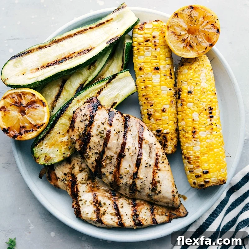 Perfectly marinated and grilled meat, served with grilled zucchini, corn, and lemons on the side.