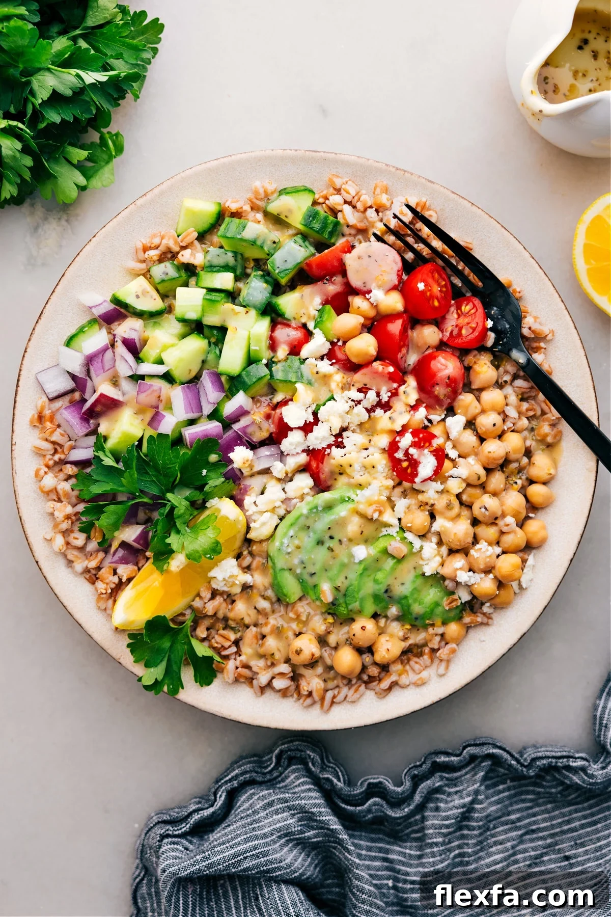 Grain bowl over farro with fresh veggies and chickpeas.