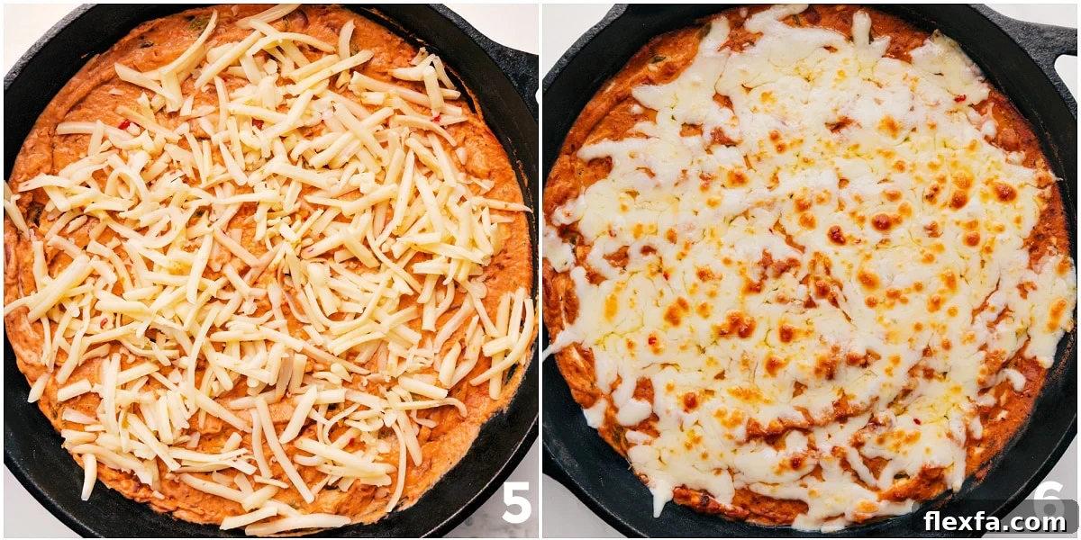 Cheese being spread over the appetizer and it all being baked to perfection.
