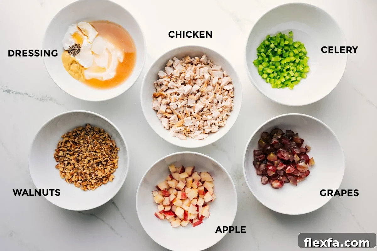 All the ingredients prepped out for easy assembly including the dressing, walnuts, apple, chicken, grapes, and celery.