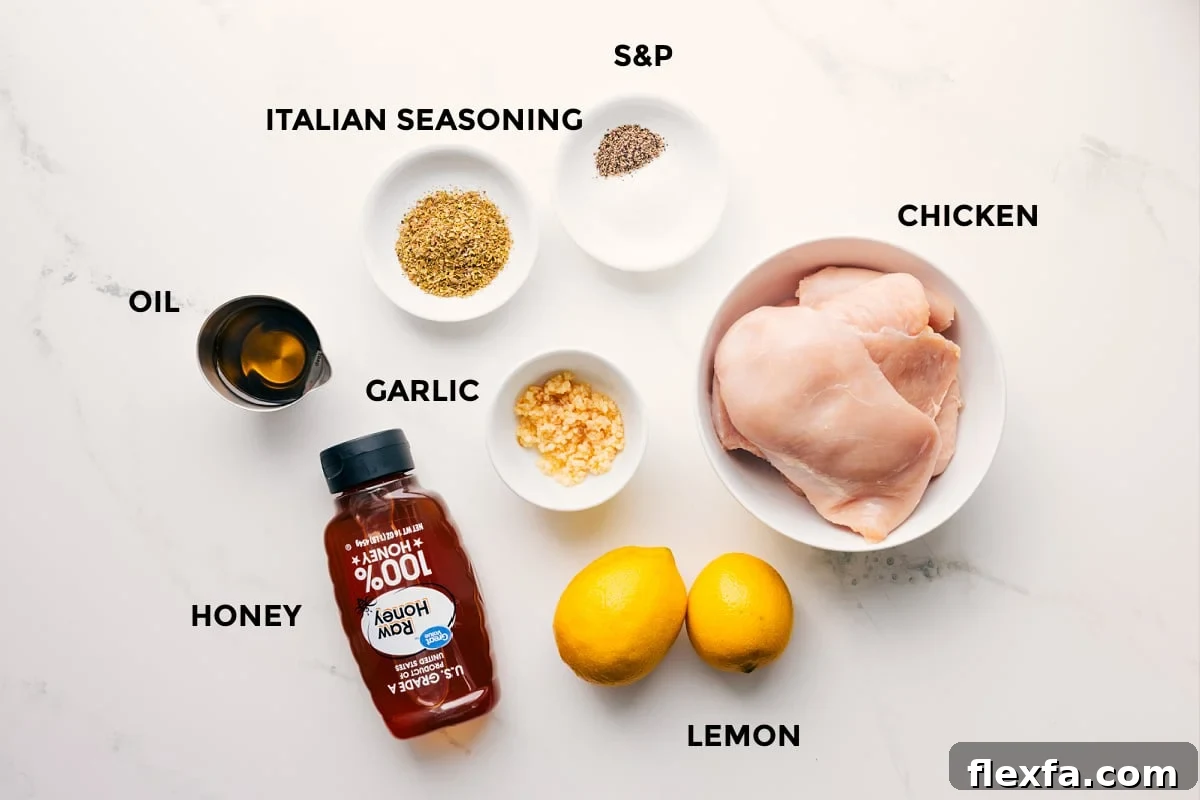 The ingredients in this recipe prepped out for easy assembly including the oil, honey, seasonings, garlic, chicken, and lemons.