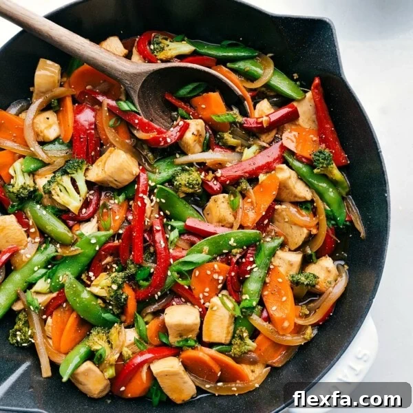 Chicken stir fry in a skillet, brimming with vegetables and rich flavors, prepared for serving.
