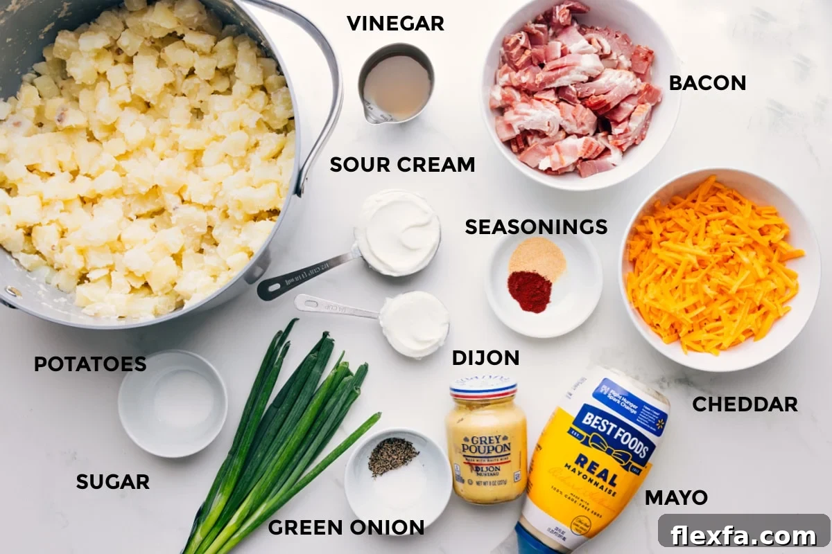 All the ingredients in this recipe prepped out for easy assembly including the potatoes, sugar, green onions, mayo, cheddar, seasonings, sour cream, vinegar, and bacon.