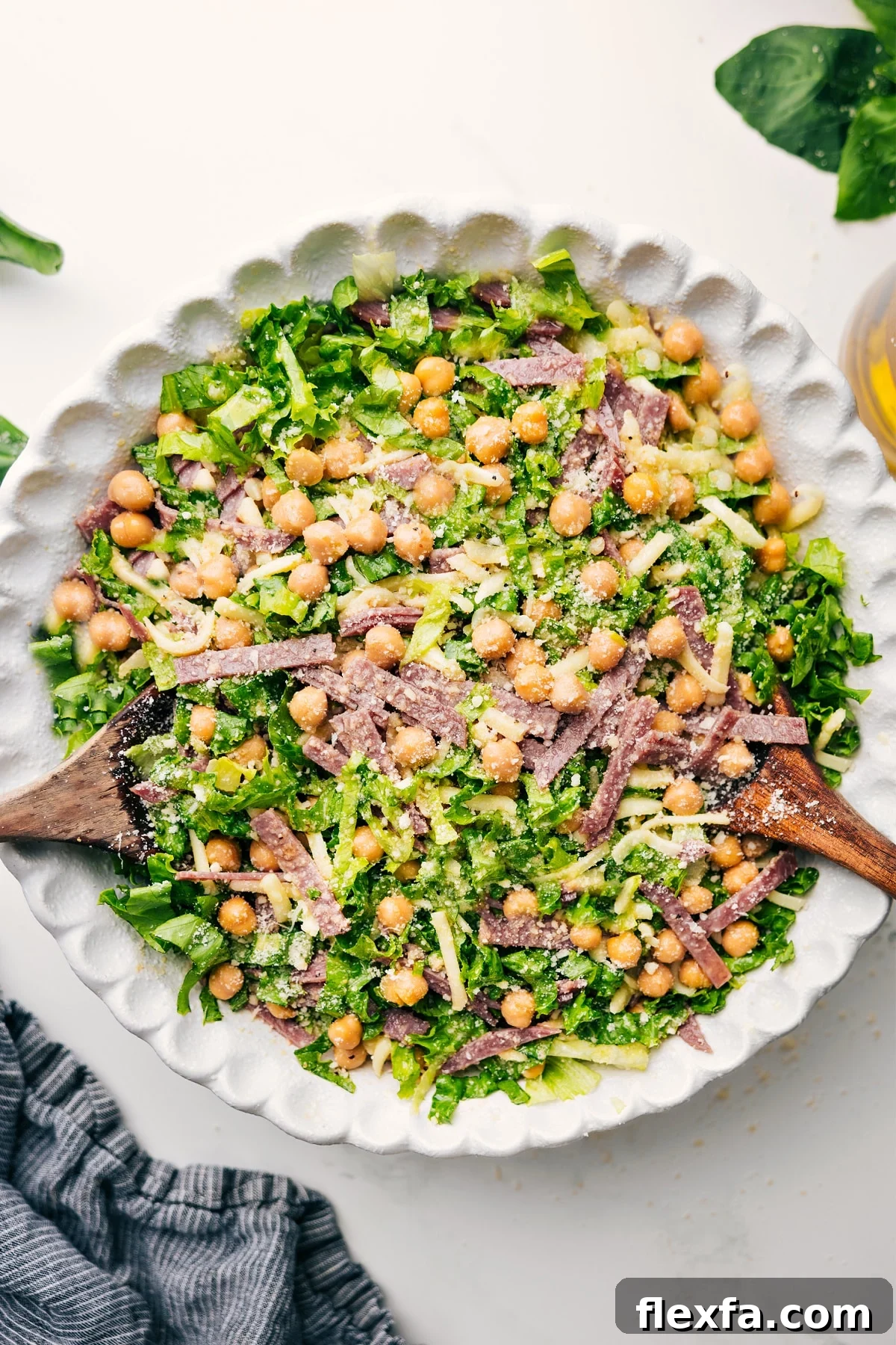 La Scala Chopped Salad tossed together in a bowl with dressing.
