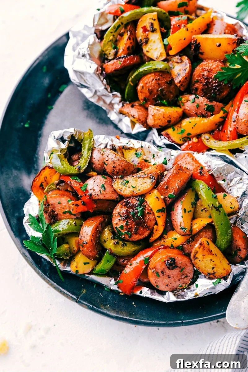 Italian recipes foil pack sausage and veggies with peppers, mushrooms, potatoes, garlic, and onions.