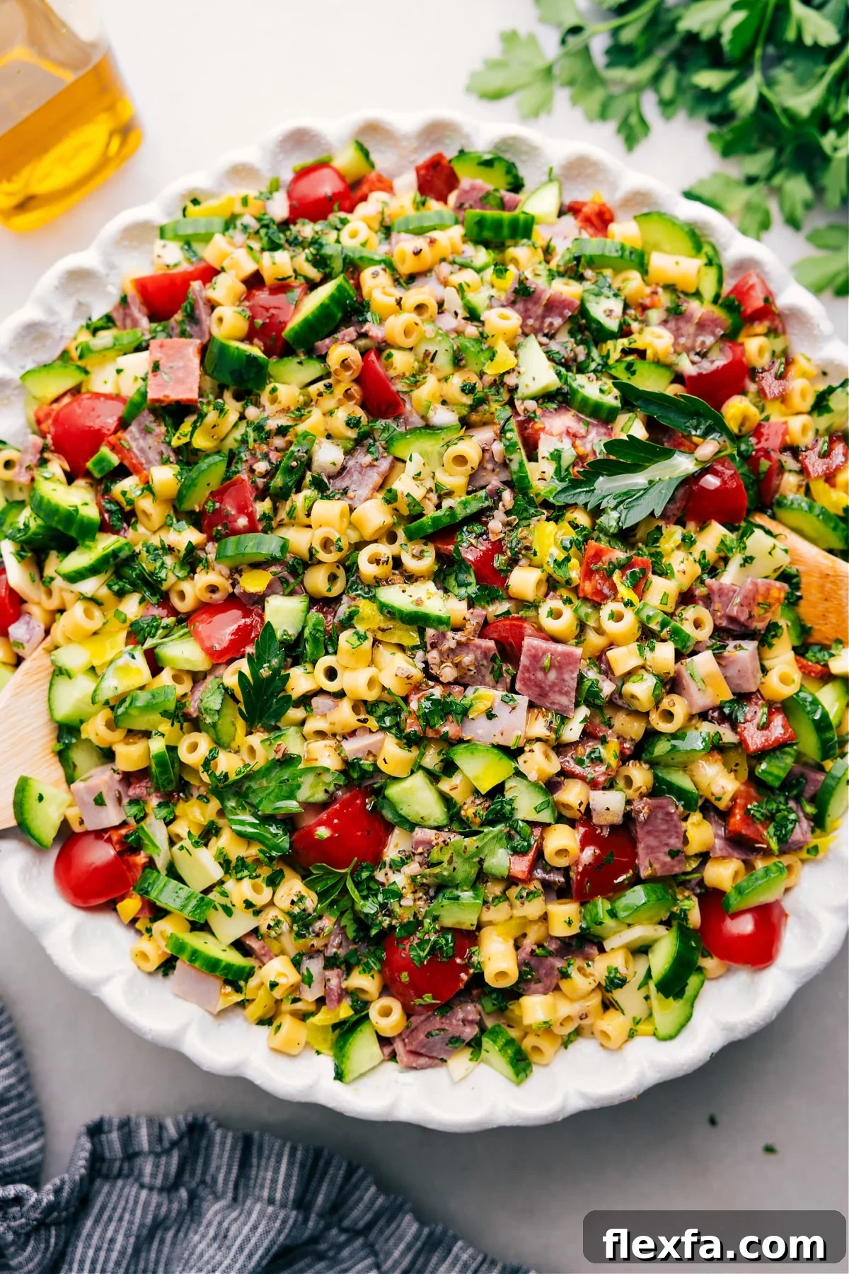 Grinder pasta salad with meats, cheese, peppers, pasta, and creamy dressing.