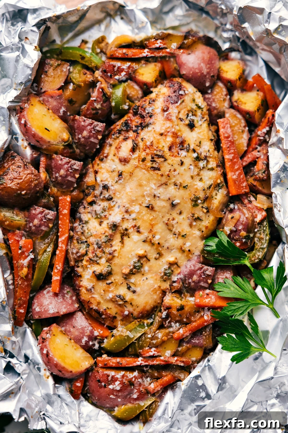 Italian recipes chicken and veggies foil pack with seasoned chicken and vegetables.
