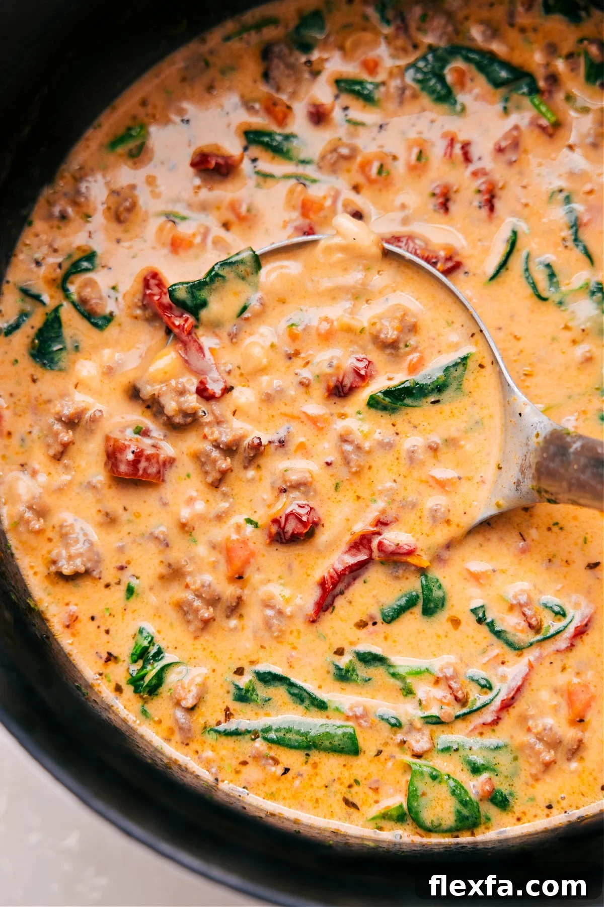 Creamy soup with sausage, bacon, white beans, sun-dried tomatoes, and rich broth.