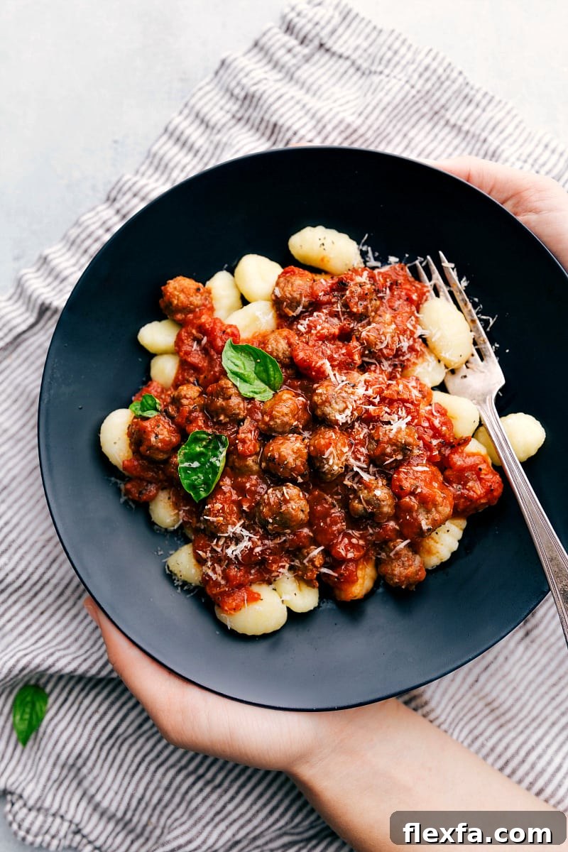 Italian recipes gnocchi with tender pasta, tomato sauce, and mini sausage meatballs.