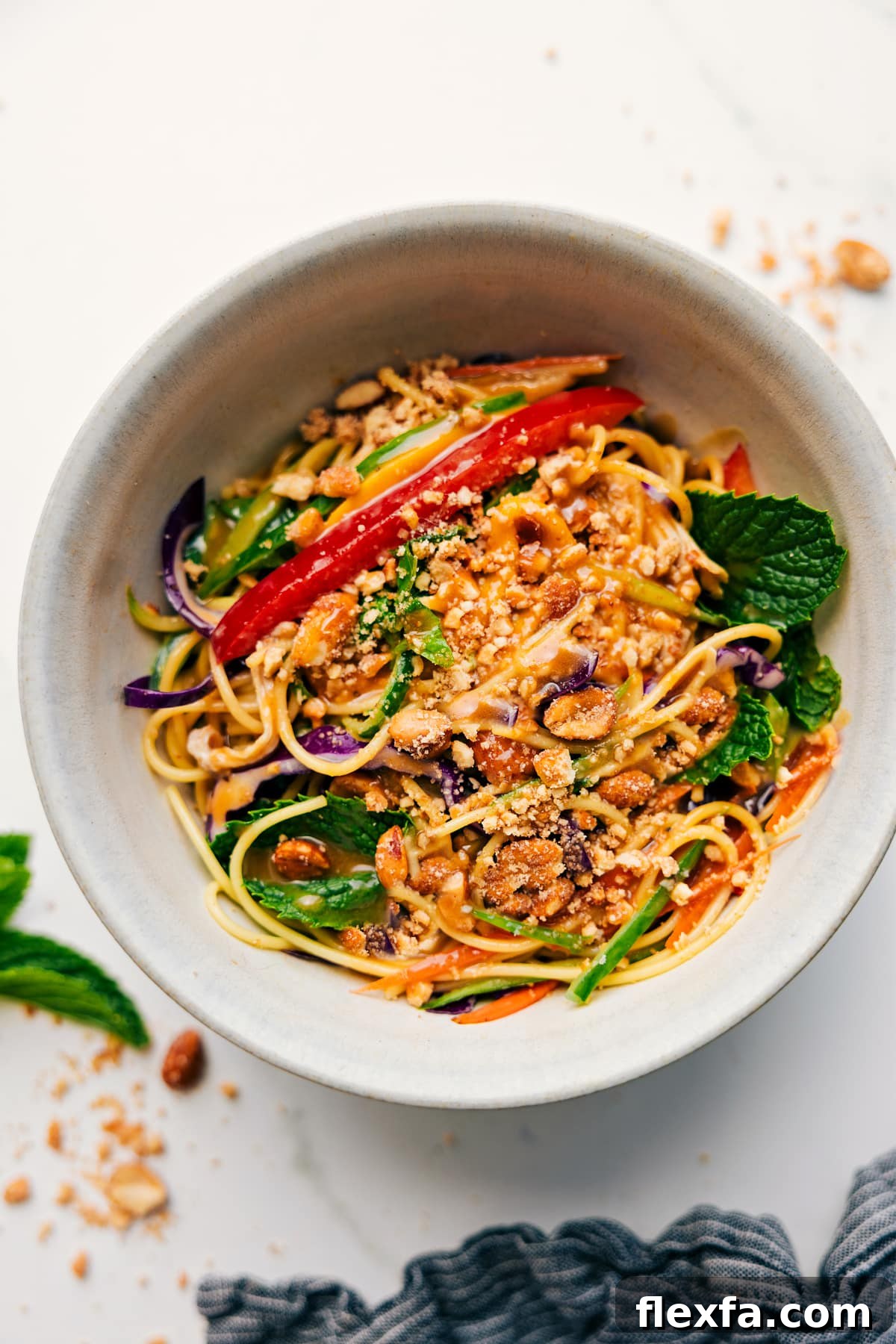 Spring Roll Salad in a bowl topped with chopped peanuts, ready to eat.