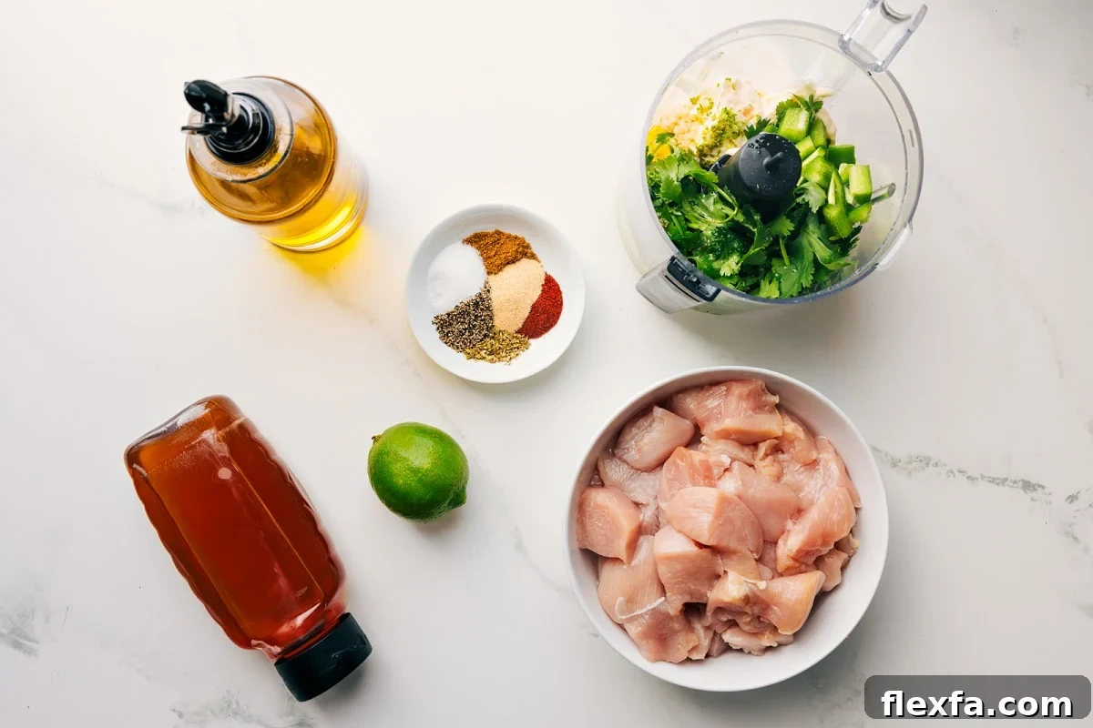 All the ingredients in this recipe prepped out for easy assembly including the honey, oil, lime, seasonings, chicken, and sauce.