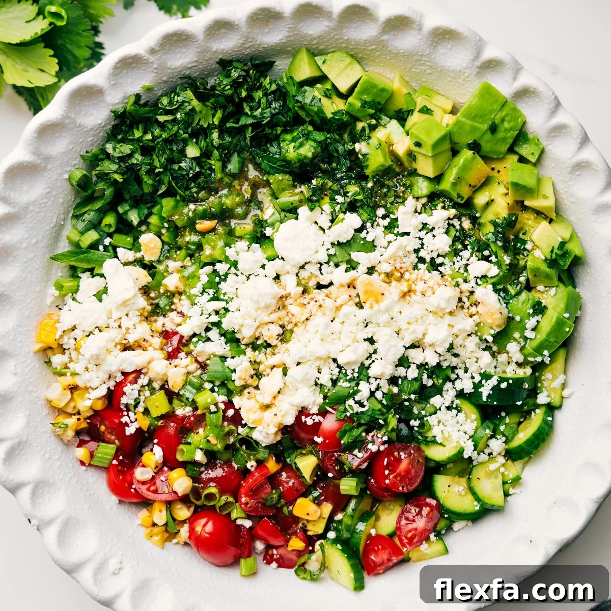 All the ingredients in this corn salad recipe added into a bowl to be tossed together.