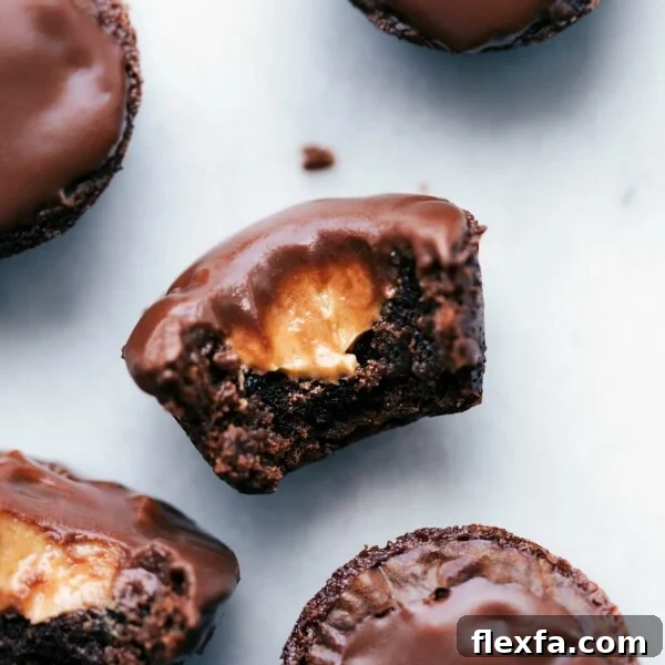 Peanut butter brownie bites with a bite taken out, revealing a melting peanut butter center.
