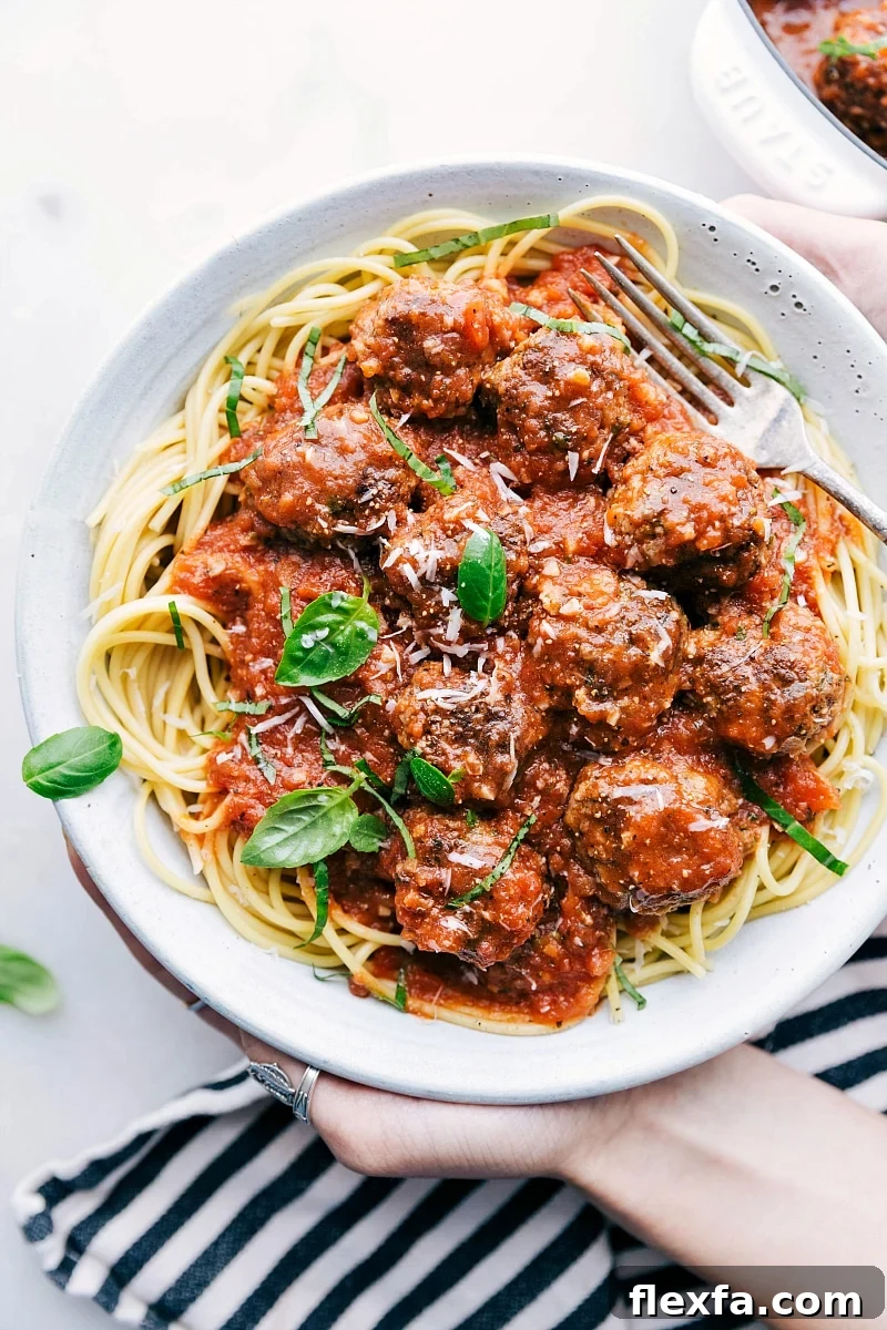 Mozzarella-stuffed meatballs in marinara are hearty easy recipes for kids served over pasta.