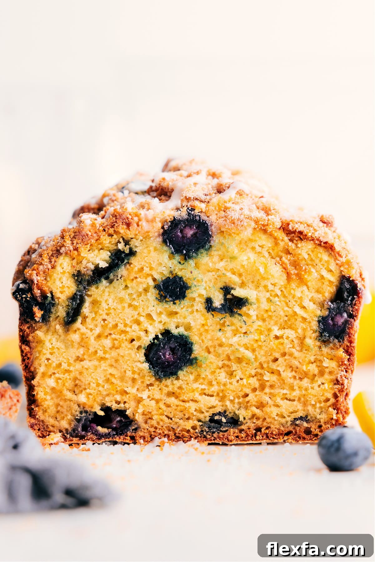 Moist lemon blueberry bread filled with juicy berries and topped with a sweet lemon glaze.