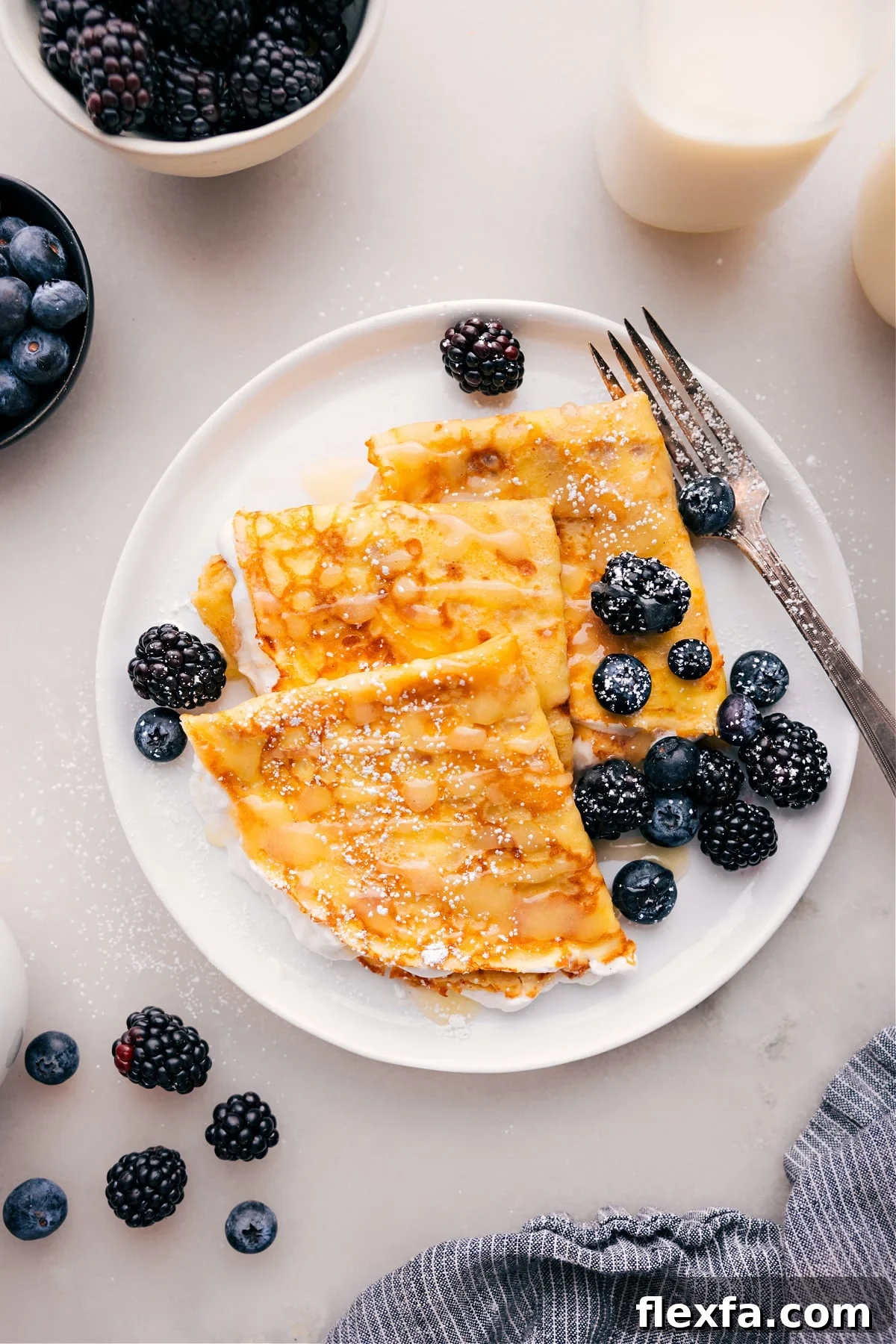 Light homemade crepes with berries, cream, and chocolate spread for sweet and easy recipes for kids.