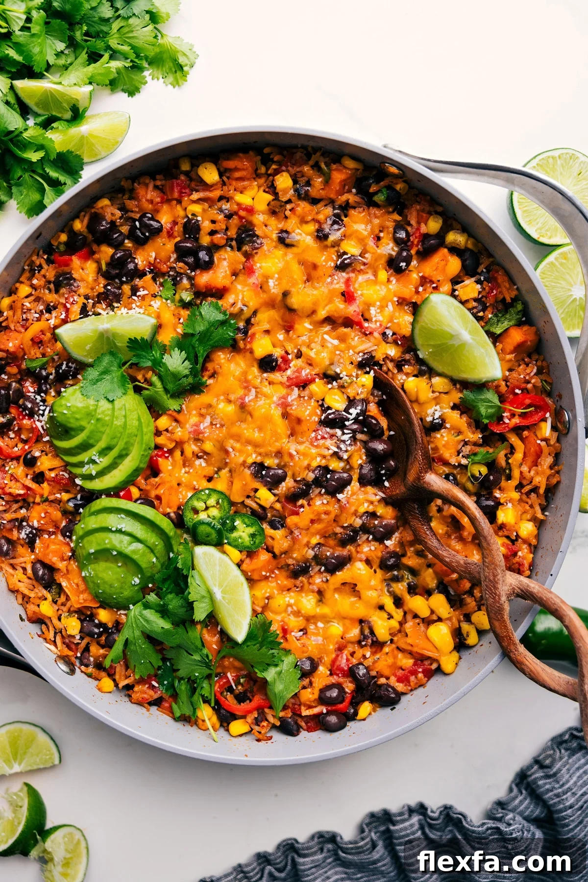 A cheesy chicken burrito bowl with rice, beans, corn, and tomatoes makes easy recipes for kids simple.