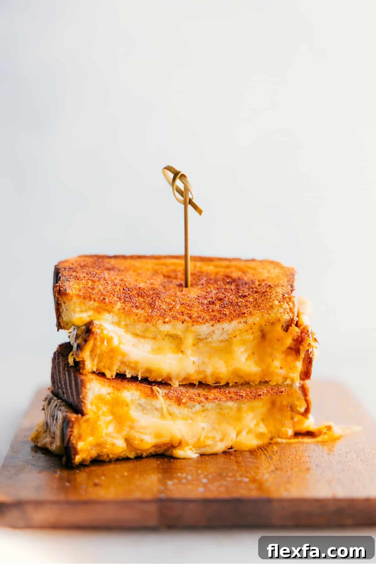Stacked grilled cheese sandwiches are classic easy recipes for kids with a gooey three-cheese center.