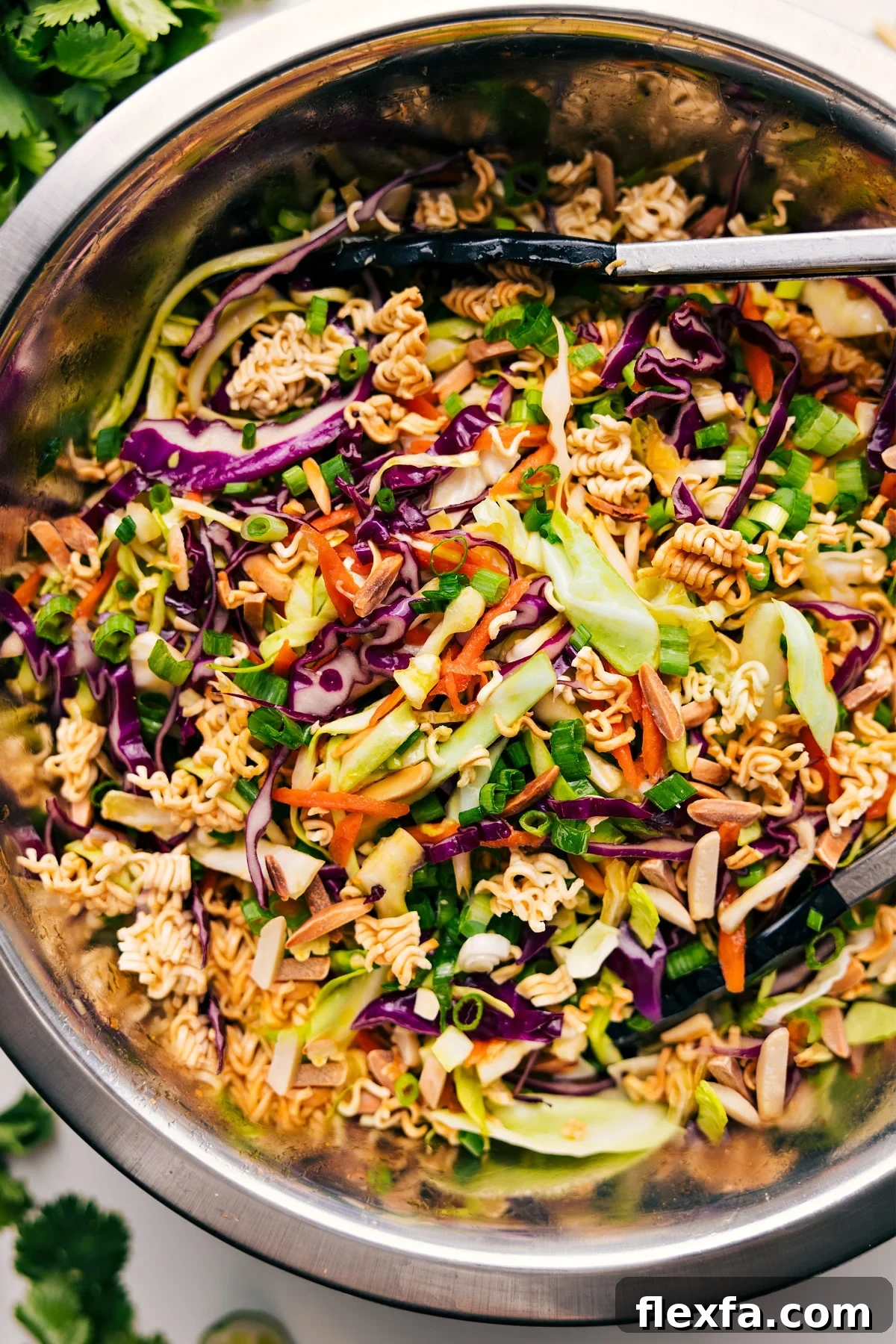 Crunchy ramen noodle salad with fresh cabbage, toasted almonds, and sesame dressing.