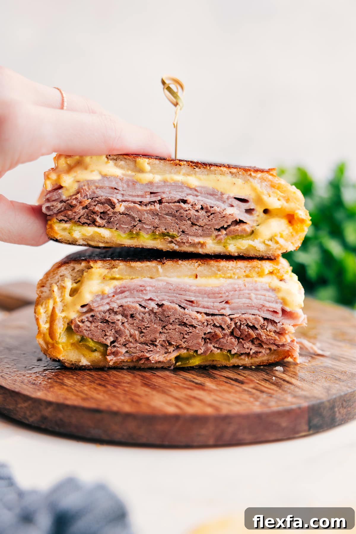 Cuban sandwich with pork, ham, Swiss cheese, pickles, and mustard on pressed bread.