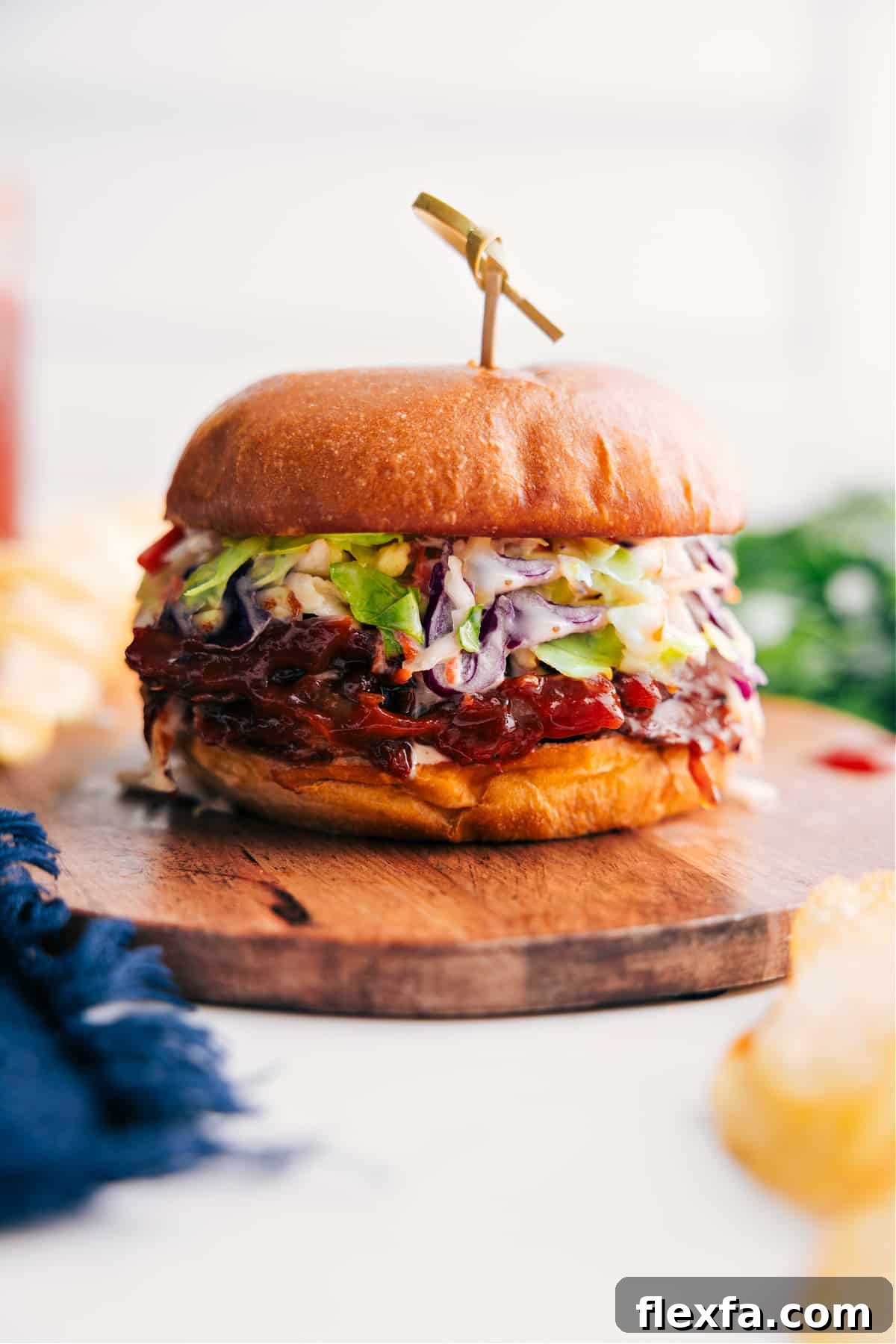 Pulled pork sandwich with tender barbecue pork and crunchy slaw on a buttered bun.
