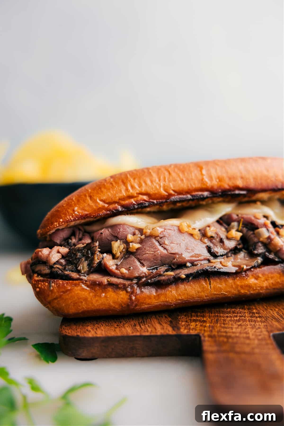 French dip sandwich with tender beef and melted cheese served with au jus.
