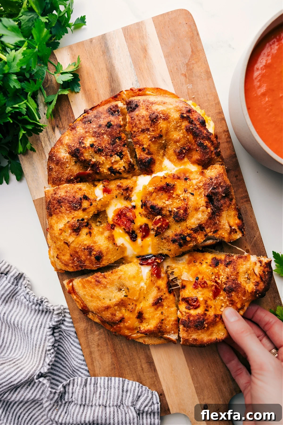 Focaccia grilled cheese with three melted cheeses, pesto, and sun-dried tomato Parmesan bread.
