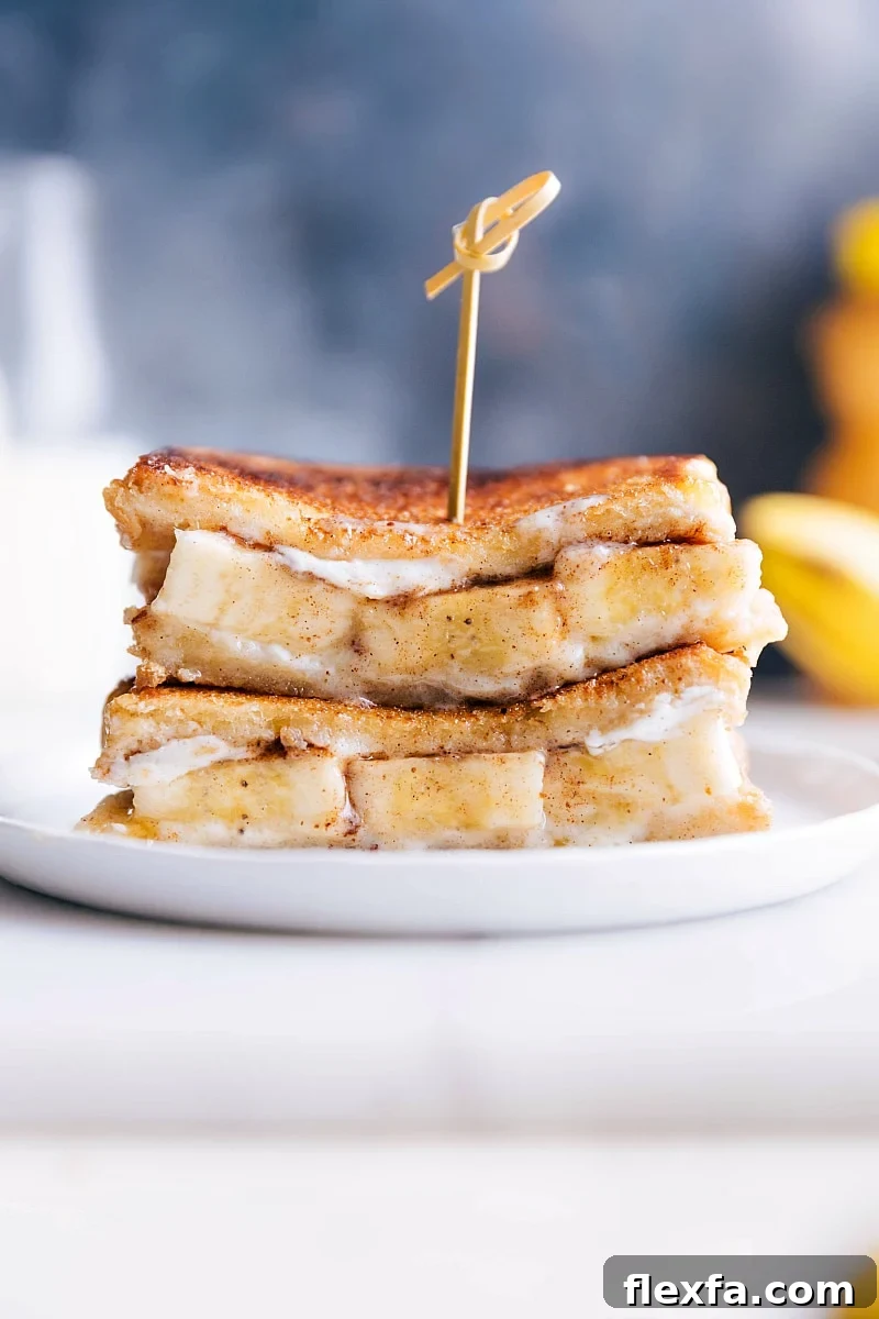 Grilled banana sandwich with mascarpone, sliced bananas, honey, and cinnamon on brioche.