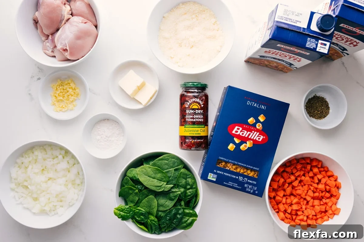 Million-Dollar Soup Recipe: Rich, Creamy Homemade Comfort 4 All the ingredients in this recipe prepped out for easy assembly including the chicken, onions, spinach, carrots, sun-dried tomatoes, pasta, seasonings, broth, butter.