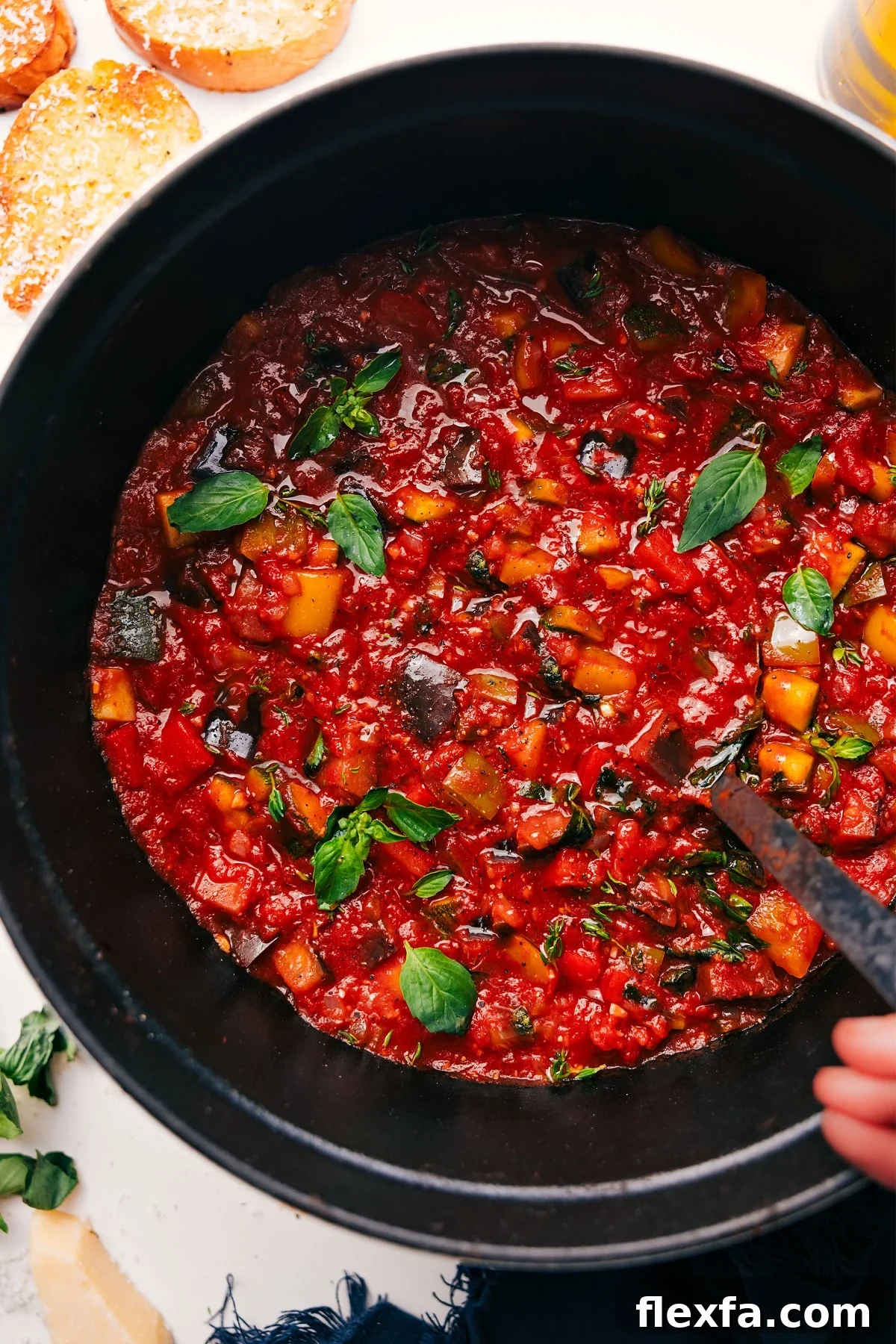 Ratatouille Soup in a pot topped with fresh basil, ready to serve.