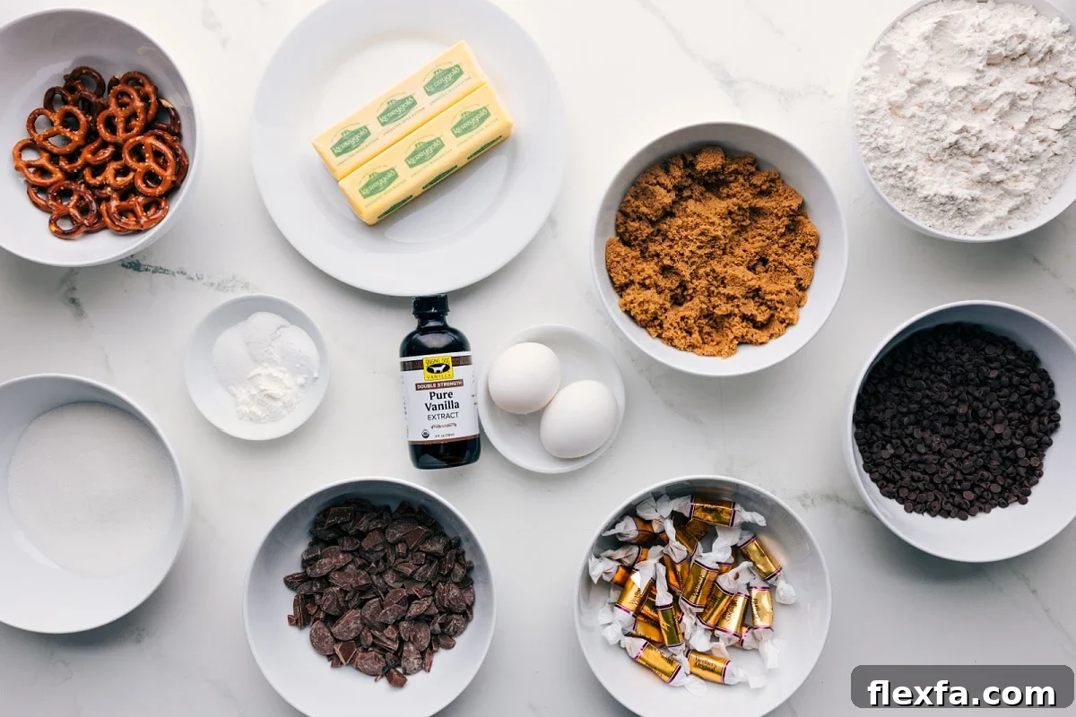 All the ingredients in this recipe prepped out for easy assembly including the pretzels, butter, sugar, baking agents, chocolate, caramels, brown sugar, and flour.