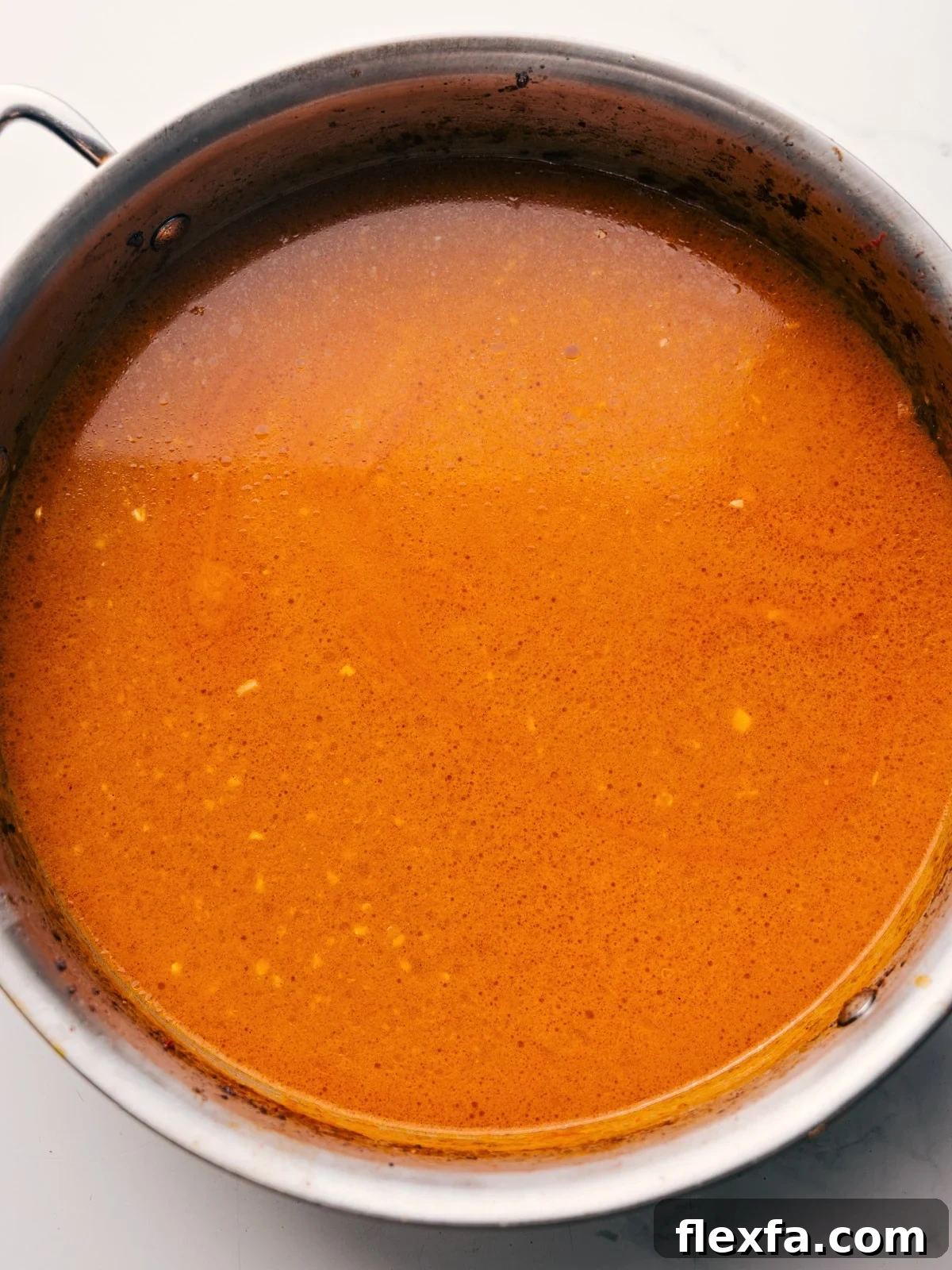The broth being whisked together in the same skillet the beef was browned in.