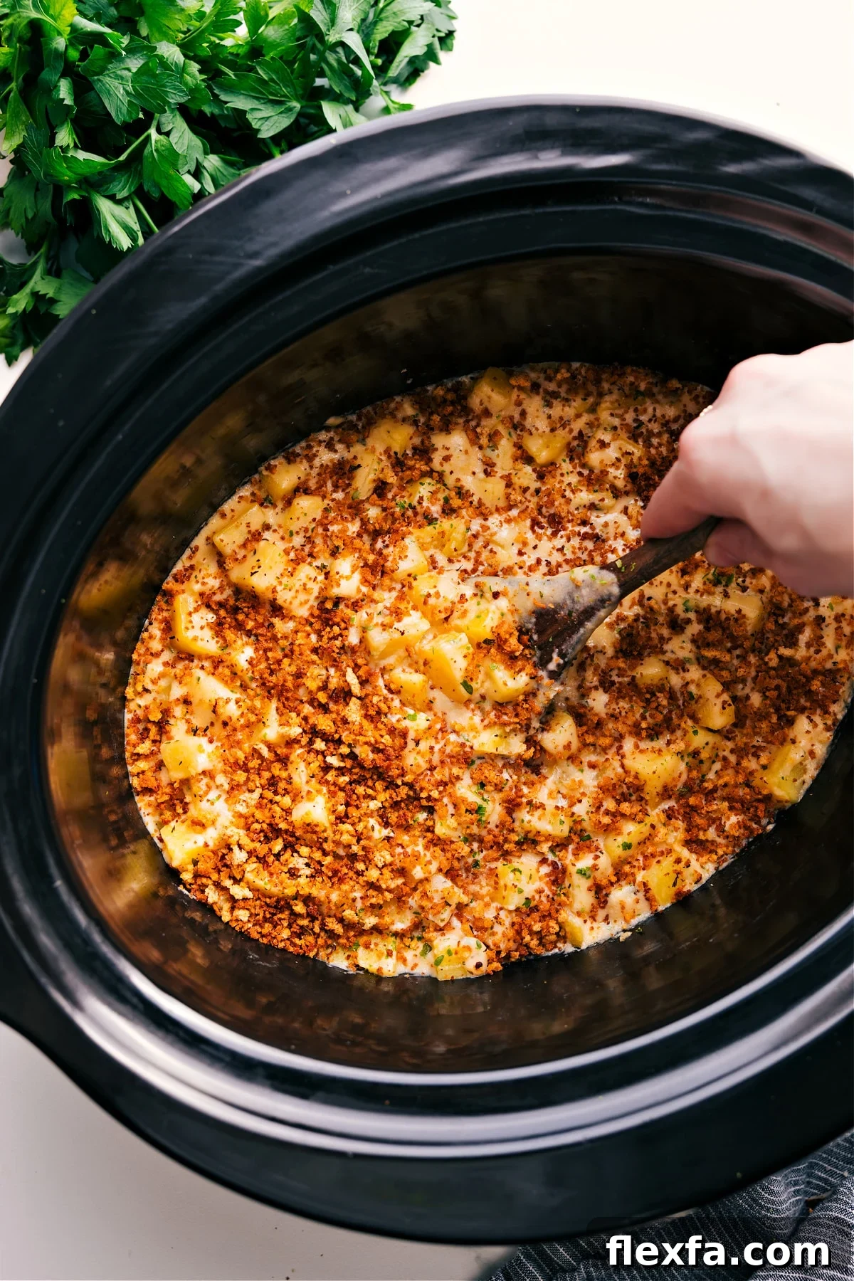 Easy crockpot meals featuring crockpot cheesy potatoes still in the slow cooker with a crunchy panko topping.