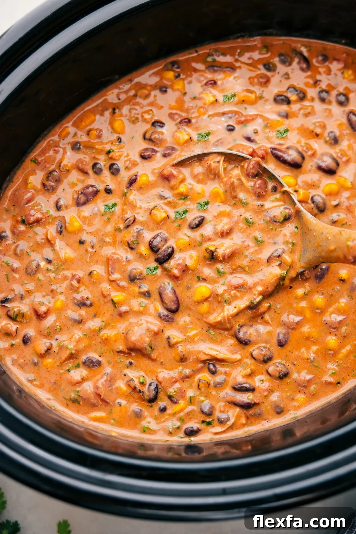 Chicken Taco Chili made in the slow cooker with tender chicken, beans, corn, and flavorful seasonings.