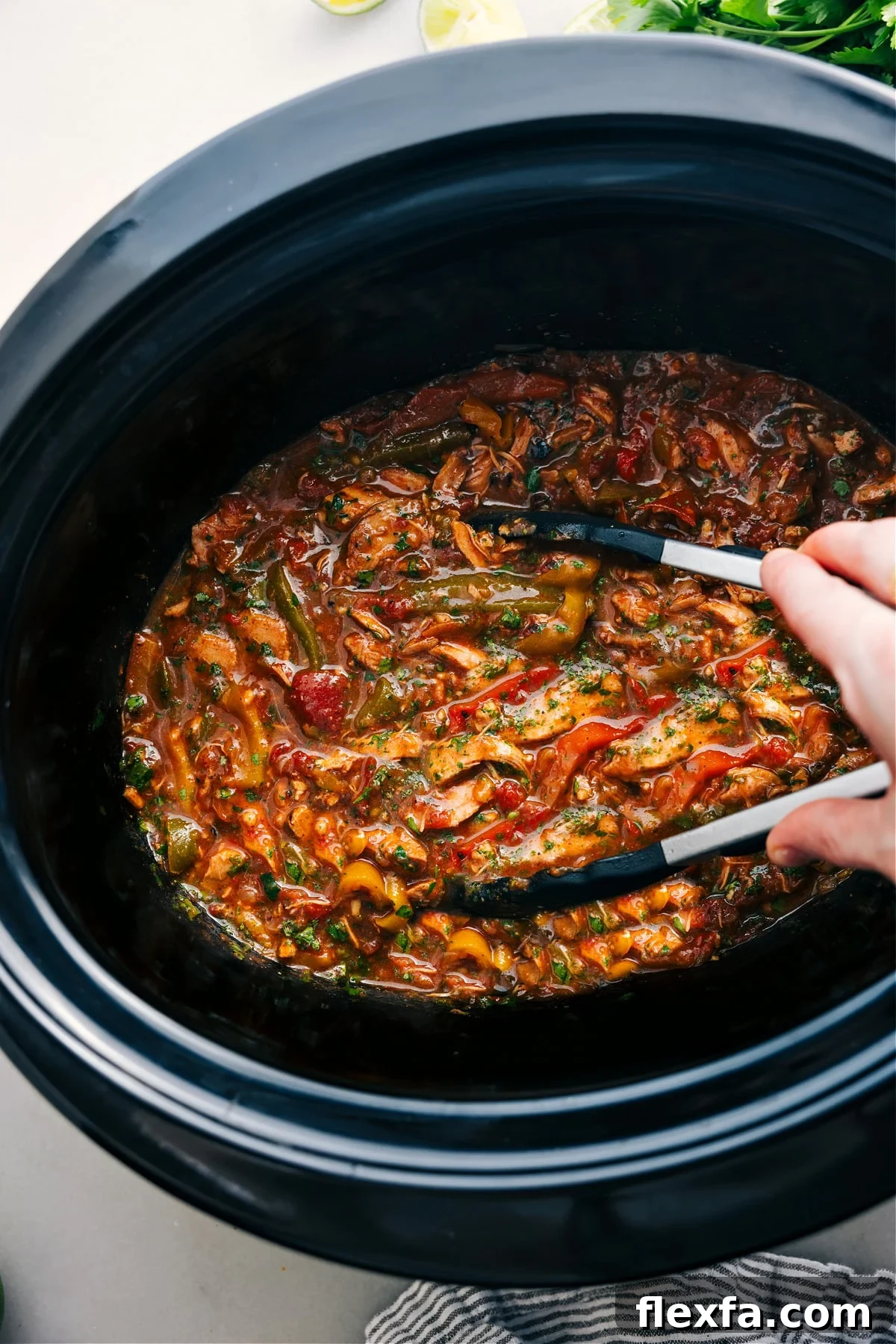 Crockpot Chicken Fajitas with tender seasoned chicken, colorful bell peppers, and onions.