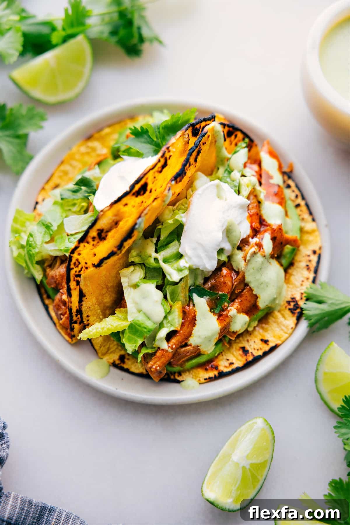 Easy crockpot meals featuring shredded chicken tacos loaded with flavorful chicken and fresh toppings.