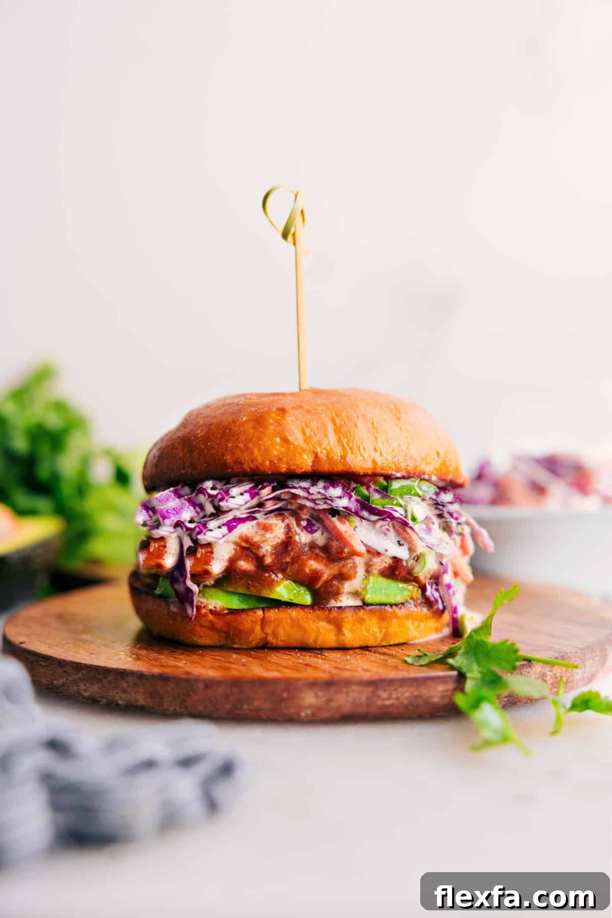 Easy crockpot meals featuring tender BBQ chicken piled onto a bun with crunchy coleslaw.