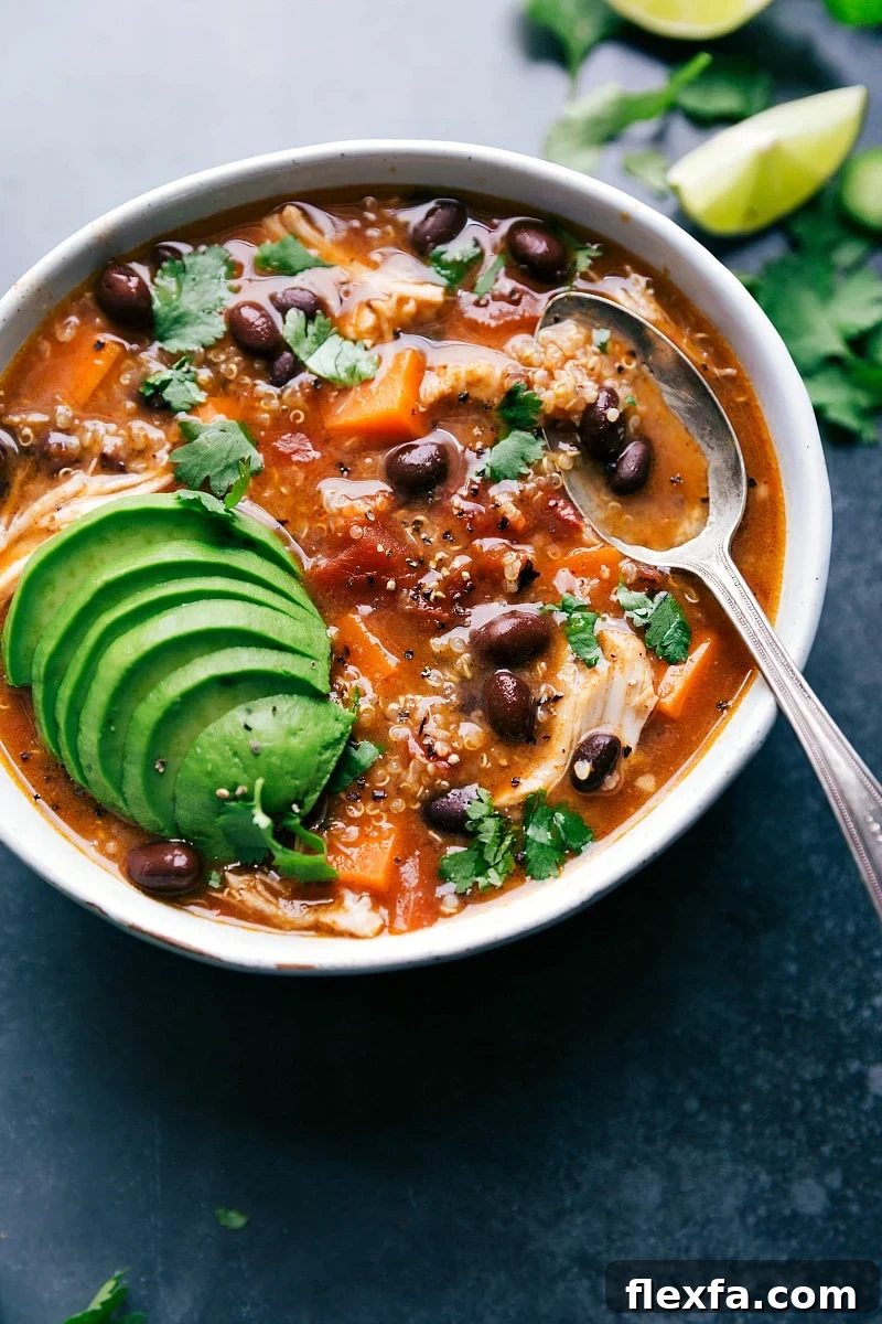 Chicken Sweet Potato Soup with tender chicken and sweet potatoes topped with avocado and fresh herbs.