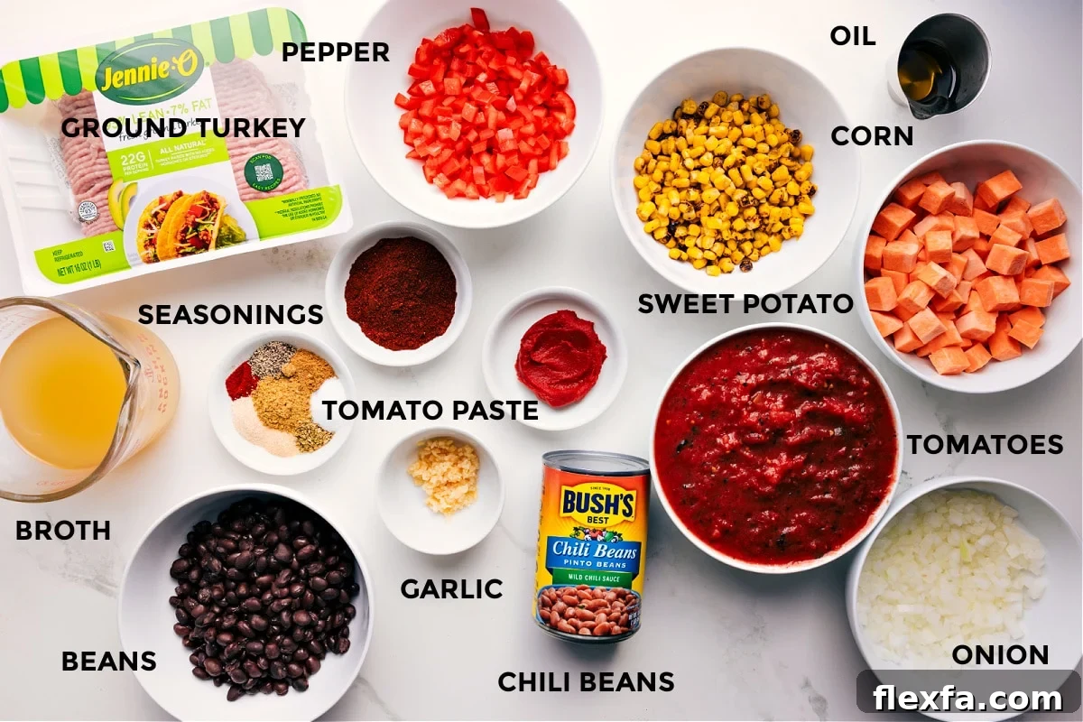 All the ingredients prepped and ready for easy assembly, including ground turkey, broth, beans, seasonings, garlic, tomato paste, bell pepper, chili beans, sweet potato, tomatoes, onion, corn, and oil.